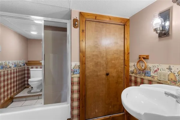 a bathroom with a sink toilet and shower