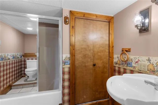 a bathroom with a sink toilet and shower