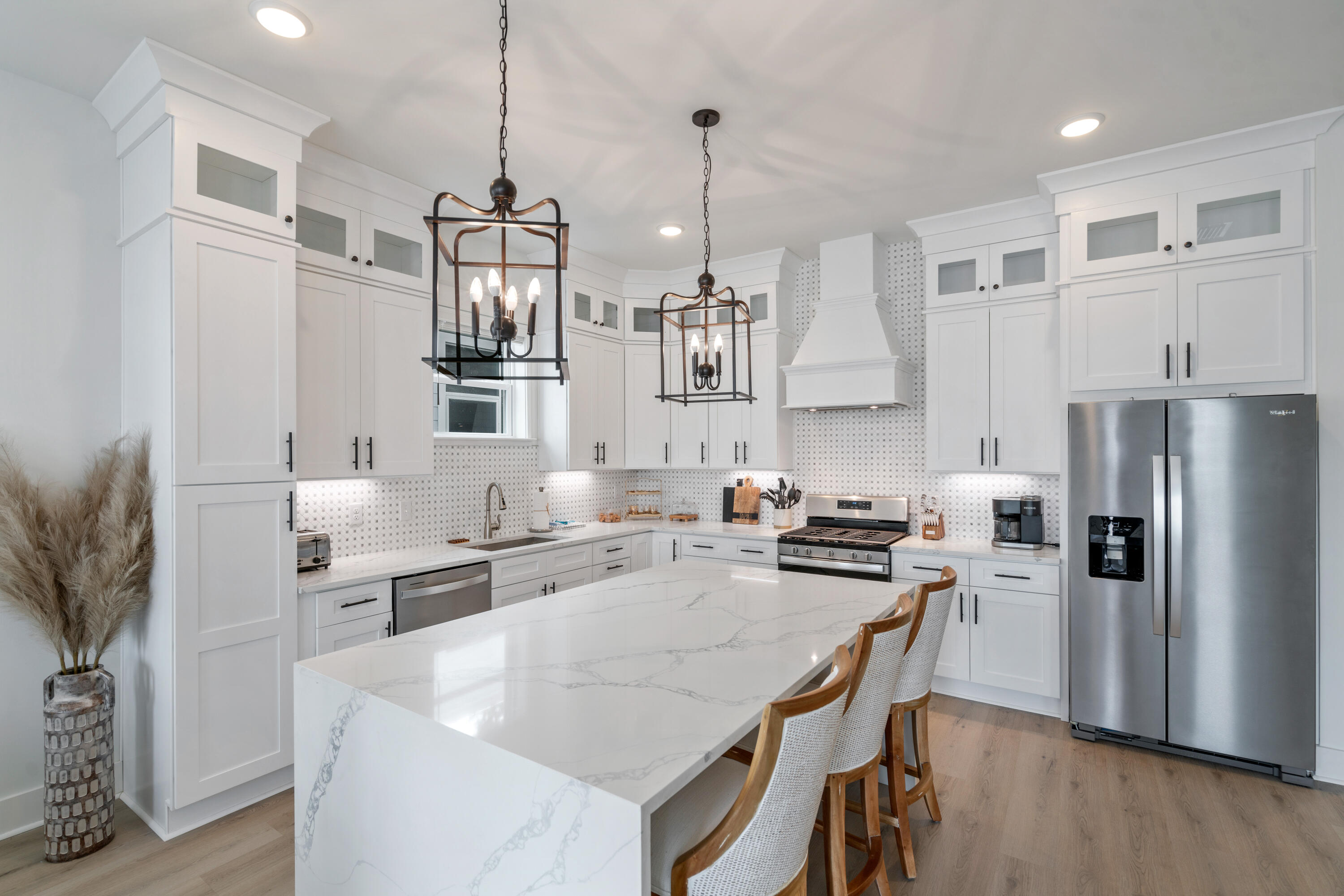 49 Conscience Way Santa Rosa Beach, FL 32459 - Photo 18 of 50 a kitchen with stainless steel appliances kitchen island a refrigerator a stove a sink a dining table and chairs