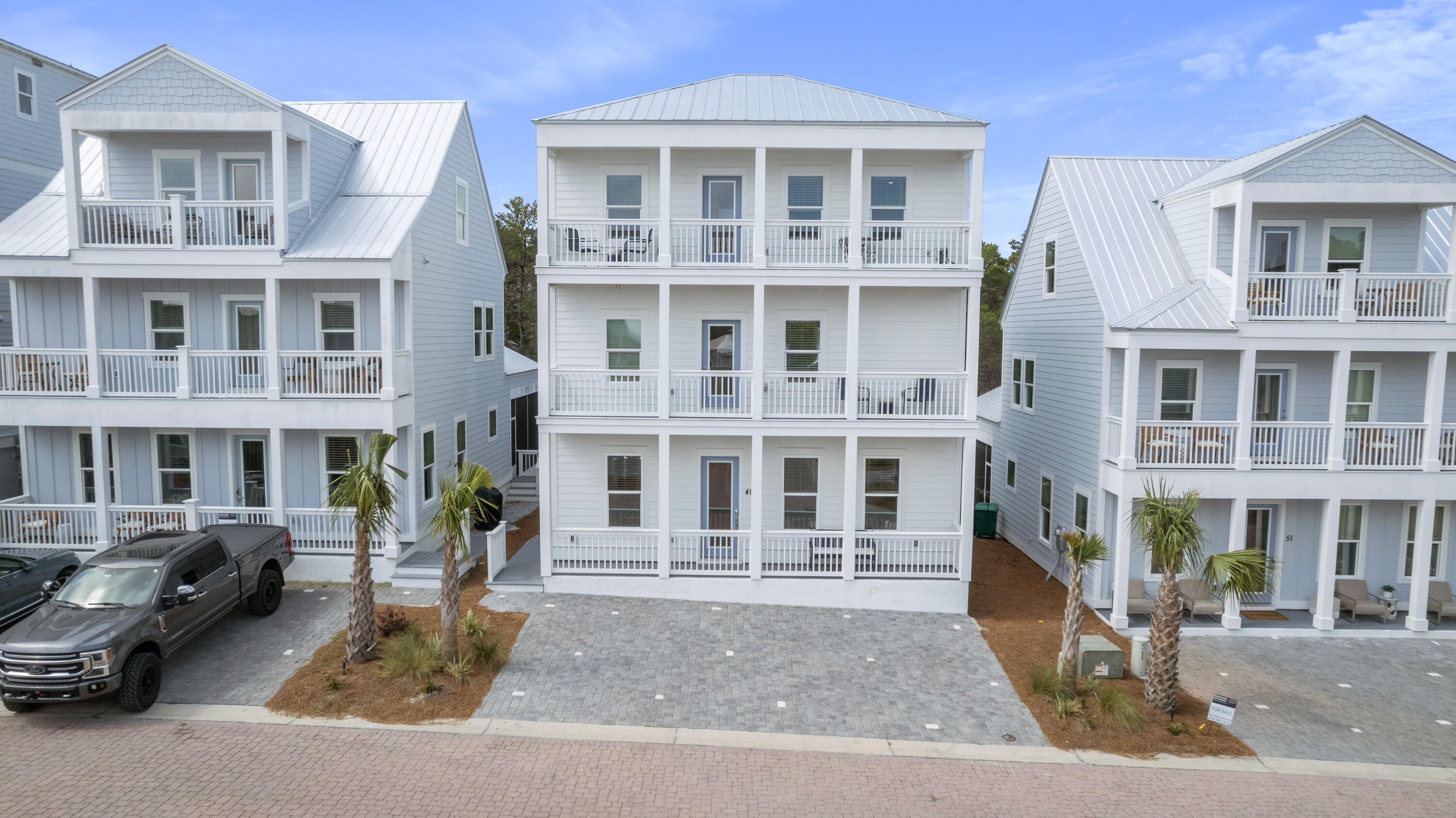 49 Conscience Way Santa Rosa Beach, FL 32459 - Photo 46 of 50 a front view of a residential apartment building with a yard