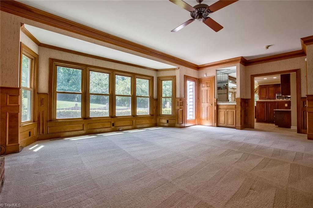 1170 Chester Road Winston-Salem, NC 27104 - Photo 11 of 30 Another view of the Great Room highlights the ceiling fan, wet bar, door to the patio and opening to the kitchen.