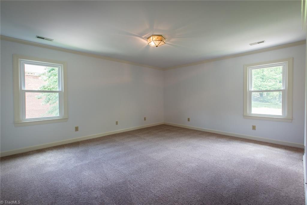 1170 Chester Road Winston-Salem, NC 27104 - Photo 18 of 30 Spacious master bedroom with crown molding, overhead light fixture and new carpeting.