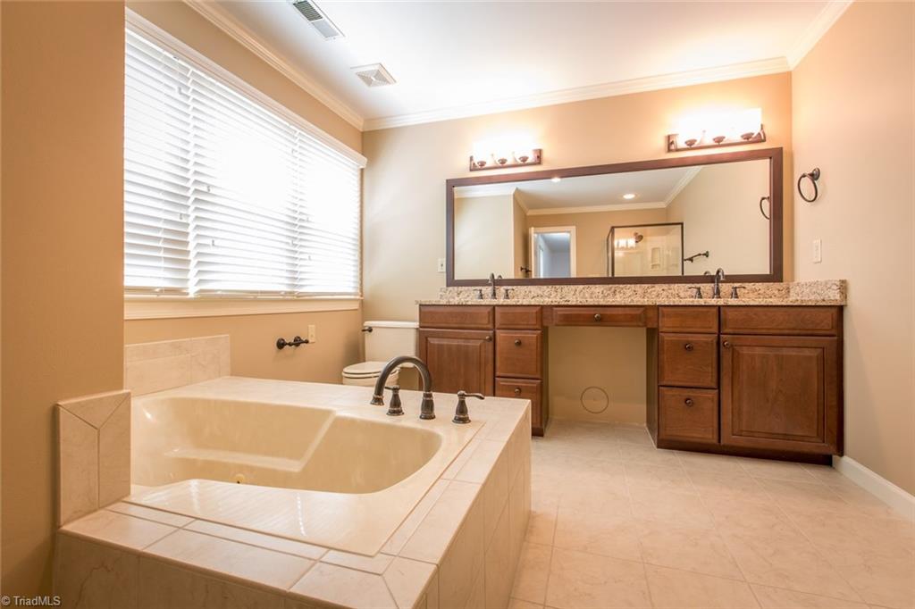 1170 Chester Road Winston-Salem, NC 27104 - Photo 20 of 30 Updated and spacious master bathroom has a jetted tub, double sinks with granite counters and oil rubbed bronze fixtures.