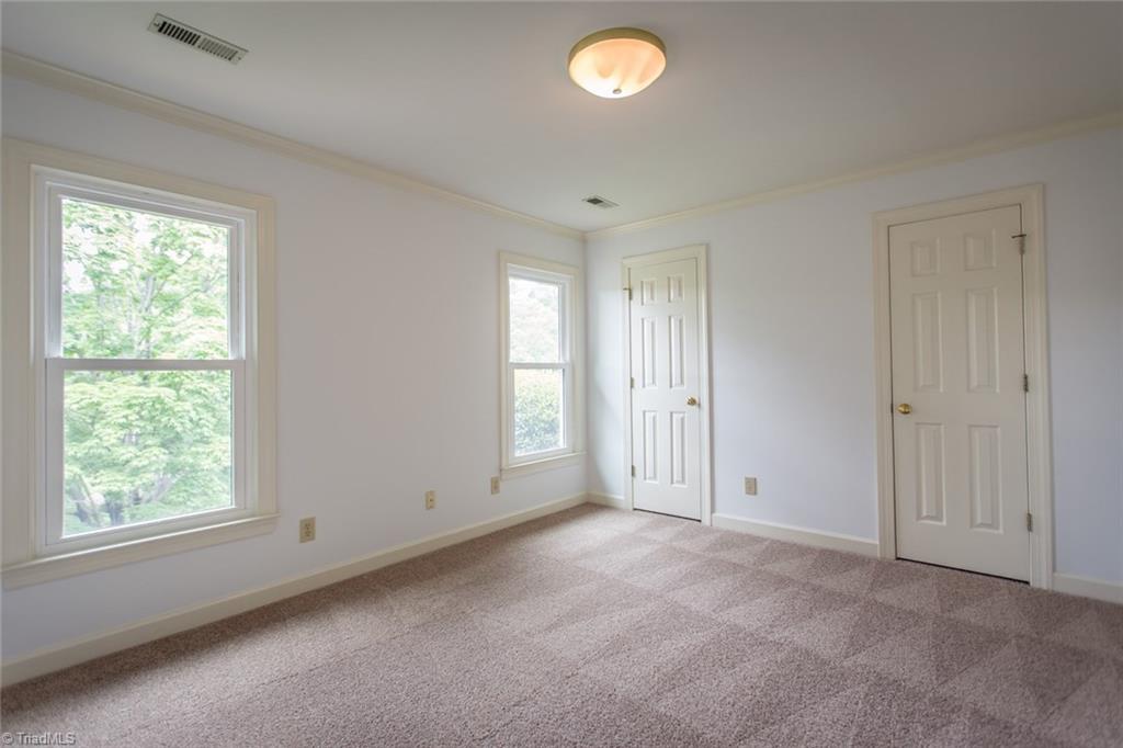 1170 Chester Road Winston-Salem, NC 27104 - Photo 23 of 30 Second bedroom has double closets, crown molding and an overhead light fixture. Freshly painted and new carpeting.