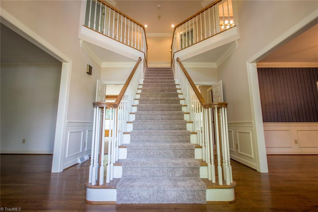 1170 Chester Road Winston-Salem, NC 27104 - Photo 5 of 30 Grand staircase to the upper level which has new carpeting. Foyer has wainscoting and hardwood floor.