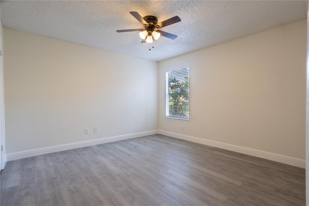 5156 Conroy Road, Unit 16 Orlando, FL 32811 - Photo 14 of 16 wooden floor in an empty room with a window
