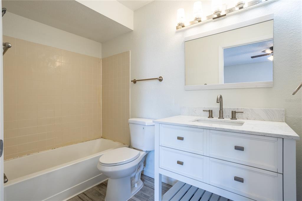 5156 Conroy Road, Unit 16 Orlando, FL 32811 - Photo 16 of 16 a bathroom with a sink a toilet and shower