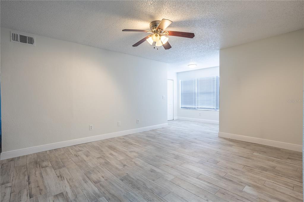 5156 Conroy Road, Unit 16 Orlando, FL 32811 - Photo 3 of 16 a view of an empty room with wooden floor
