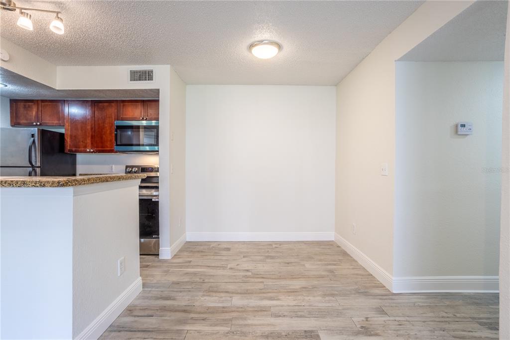 5156 Conroy Road, Unit 16 Orlando, FL 32811 - Photo 6 of 16 a kitchen with a refrigerator and a sink