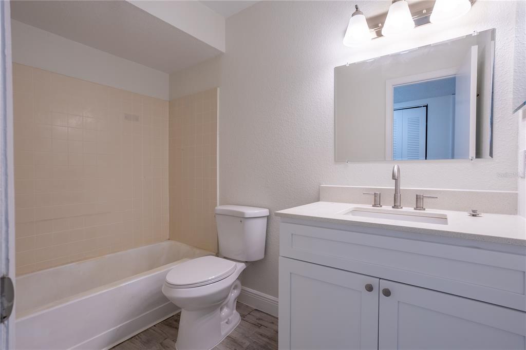 5156 Conroy Road, Unit 16 Orlando, FL 32811 - Photo 10 of 16 a bathroom with a sink a toilet and shower