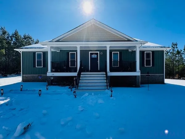 a view of a house with backyard porch and sitting area