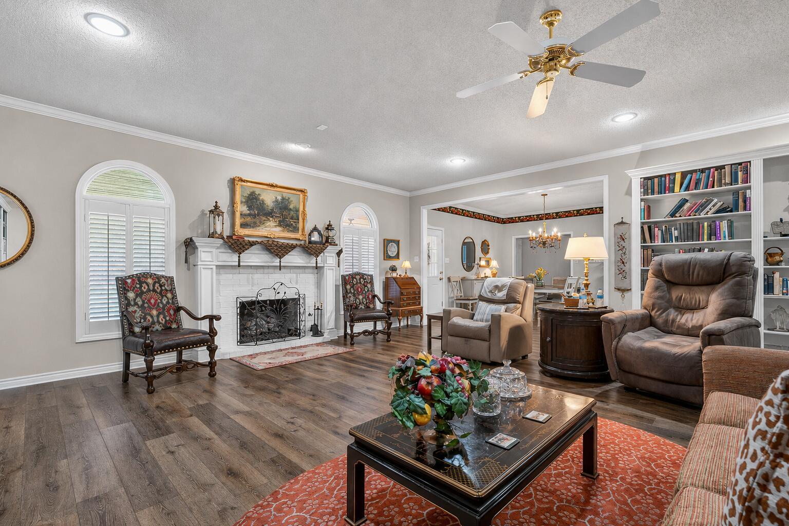 7402 95th Street Lubbock, TX 79424 - Photo 9 of 43 a living room with furniture a fireplace and a flat screen tv