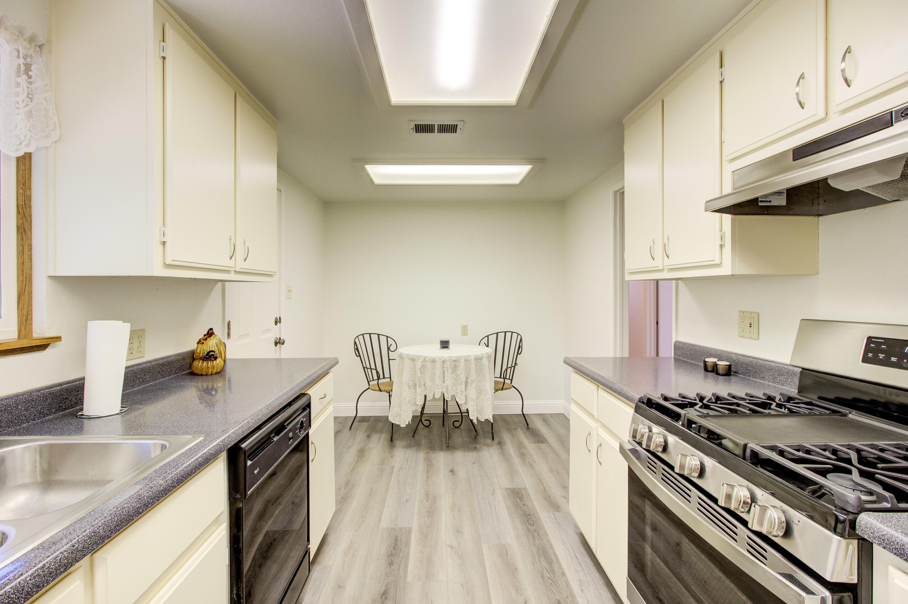 2602 Irwin Road Redding, CA 96002 - Photo 12 of 27 a kitchen with stainless steel appliances granite countertop a stove a sink and a white cabinets
