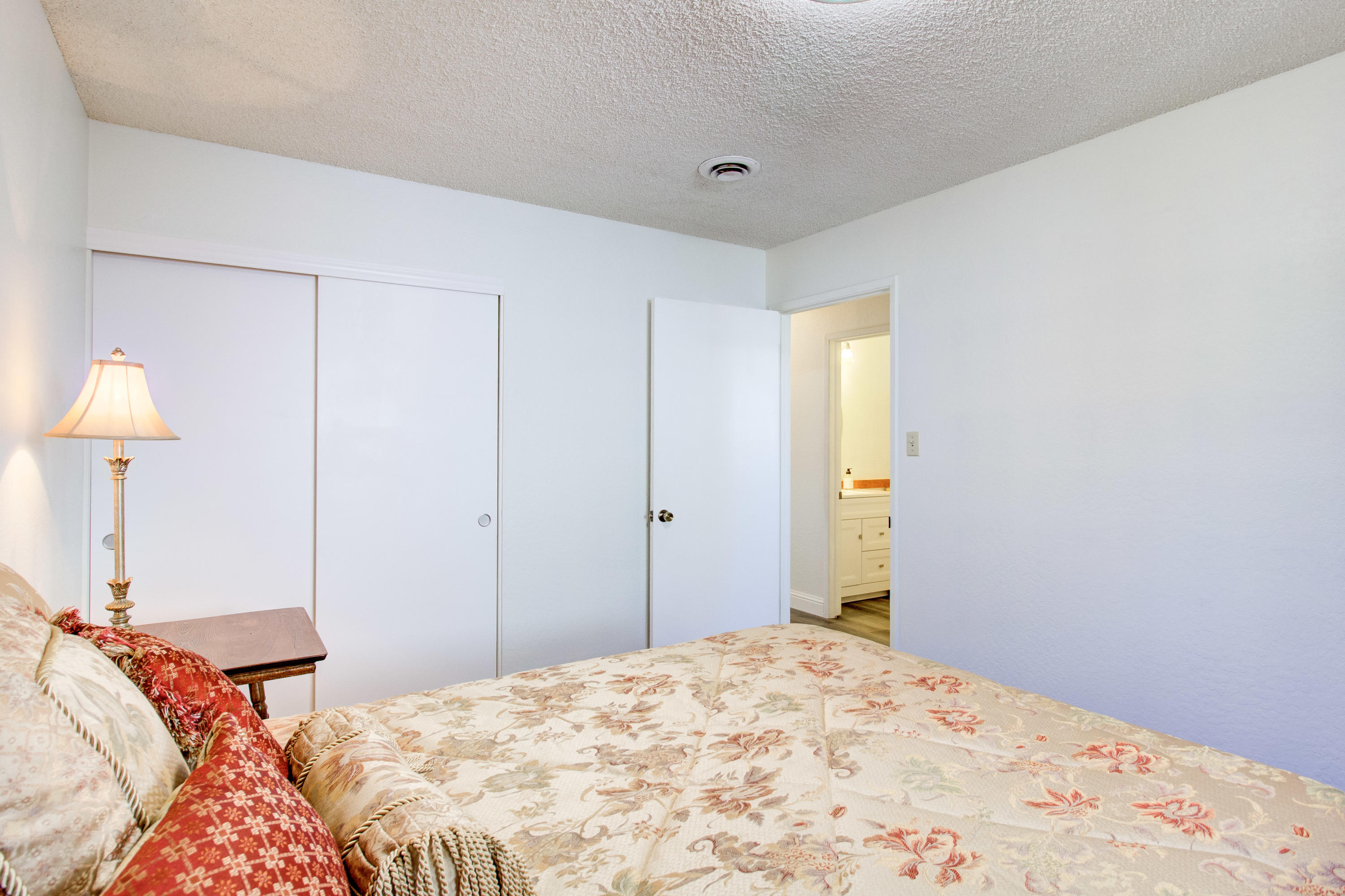 2602 Irwin Road Redding, CA 96002 - Photo 20 of 27 a bedroom with a bed and a lamp