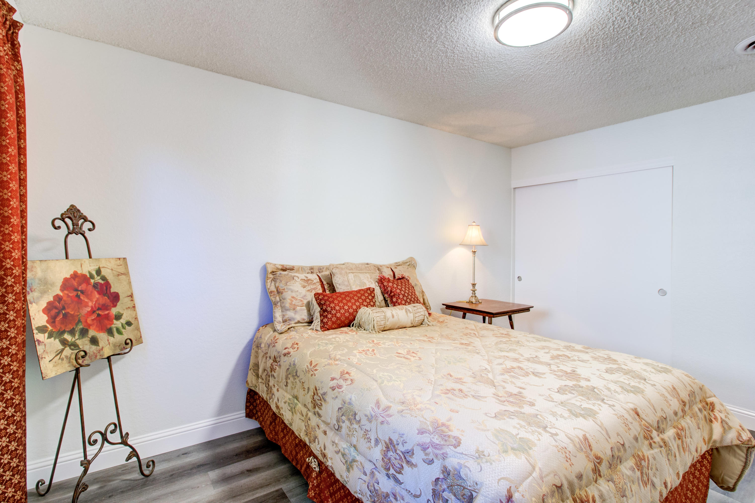 2602 Irwin Road Redding, CA 96002 - Photo 21 of 27 a bedroom with a bed and a chandelier