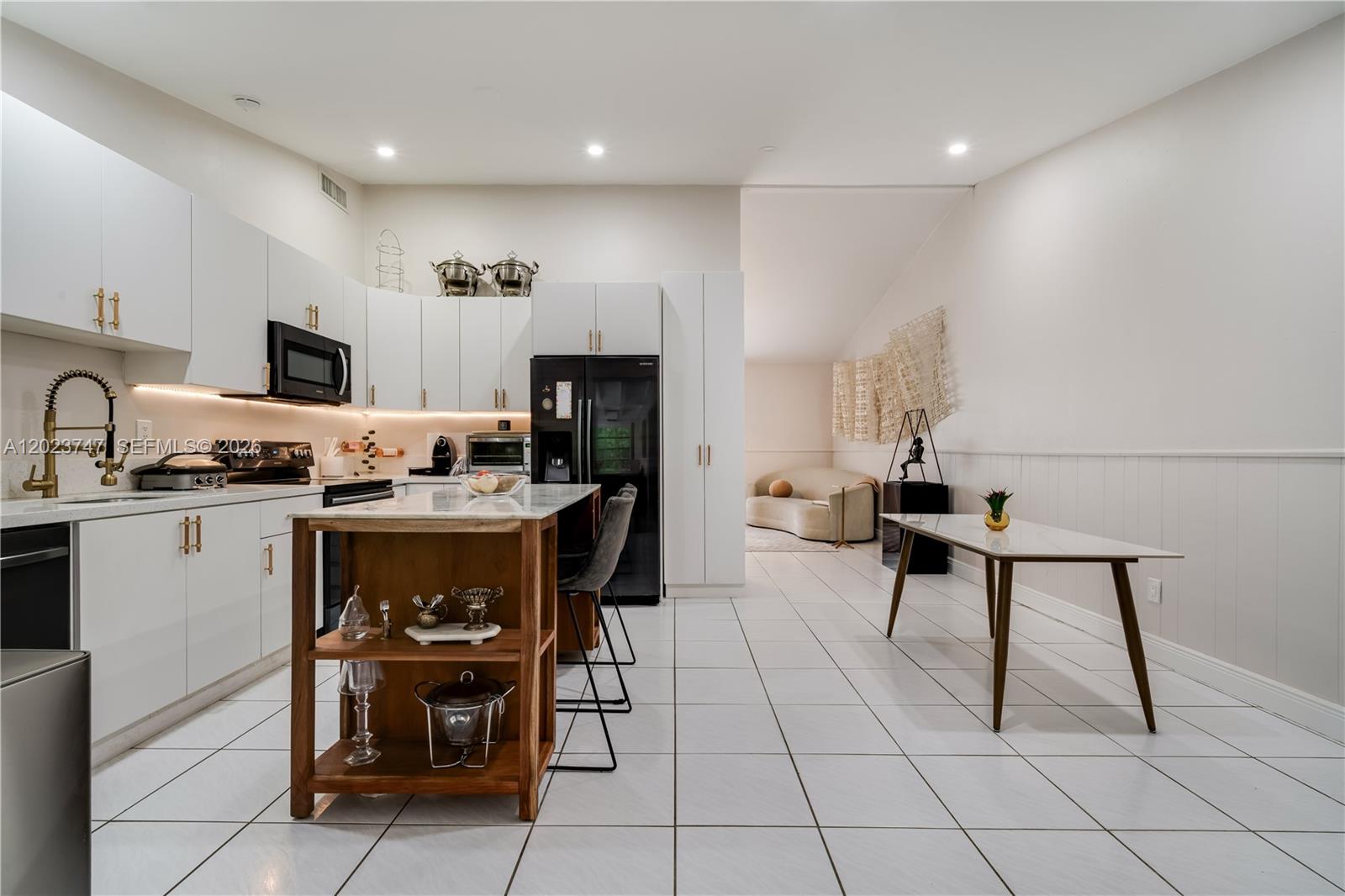11515 Southwest 81st Road, Unit 11515 Pinecrest, FL 33156 - Photo 11 of 33 a kitchen with stainless steel appliances kitchen island granite countertop a sink and cabinets