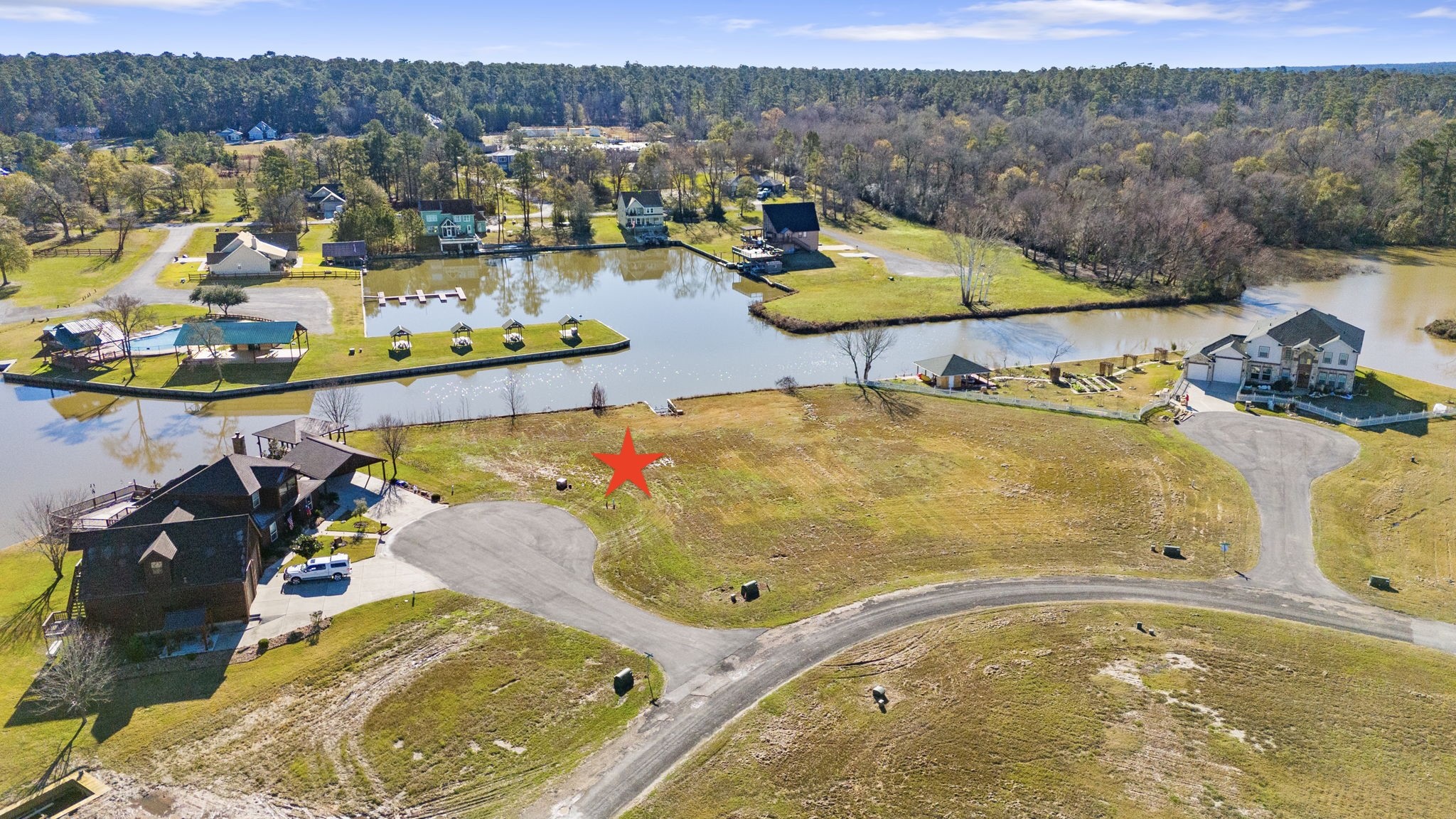 5 Island Point Huntsville, TX 77340 - Photo 5 of 15 One of the community pools and the community marina are across the WIDE canal from your lot for added beauty and water views...NO NEIGHBOR across the way looking back at you....