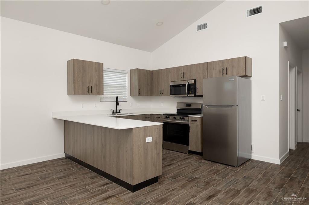2608 Robin Road Weslaco, TX 78596 - Photo 6 of 14 a kitchen with stainless steel appliances a sink stove and refrigerator