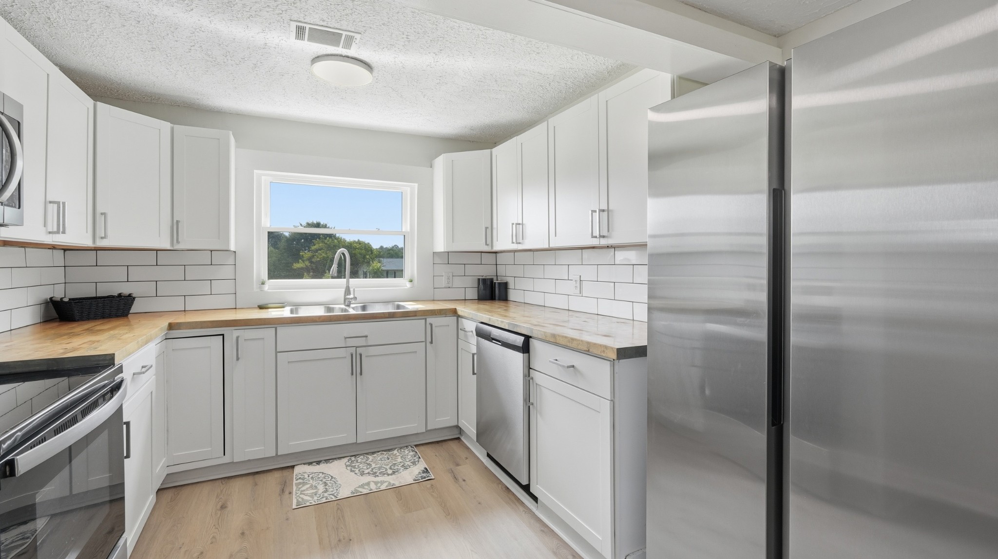 469 Fred Cooper Road McMinnville, TN 37110 - Photo 15 of 46 a kitchen with white cabinets and white appliances