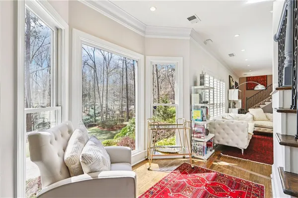 a living room with furniture and a floor to ceiling window