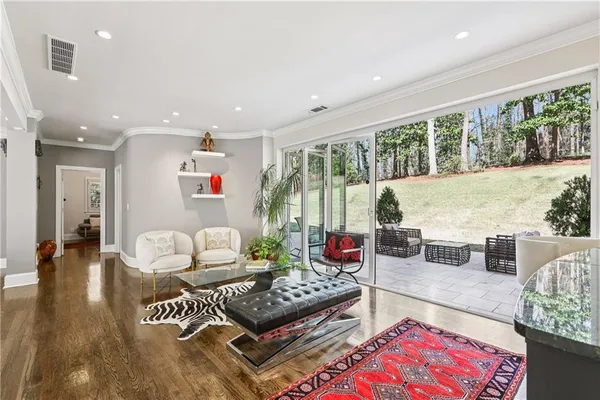 a living room with furniture fireplace and a large window