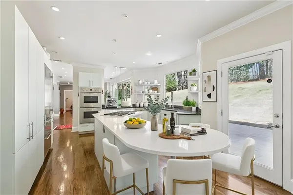 a large kitchen with a table and chairs