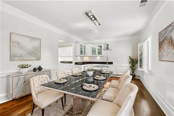 a spacious bedroom with a bed a couch and large window with outer view