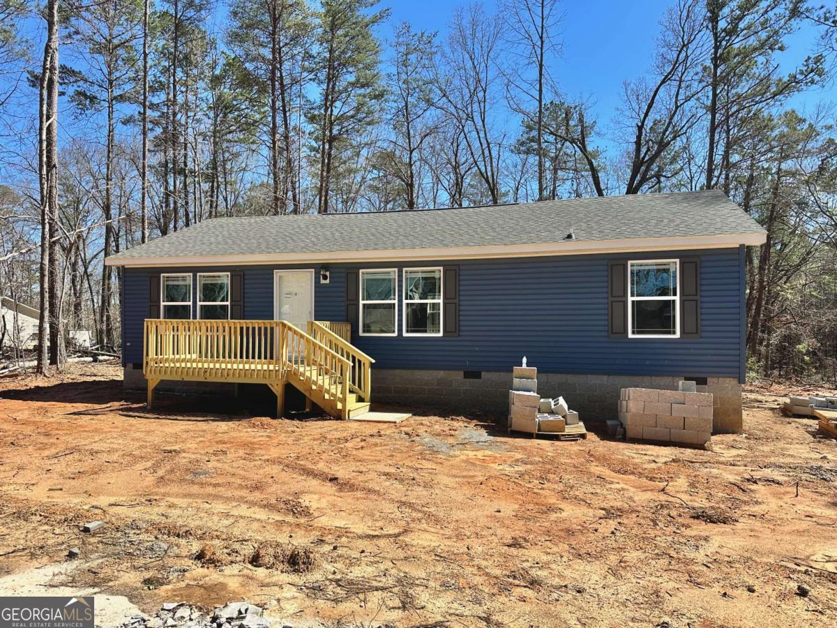 a front view of a house with a yard covered in snow