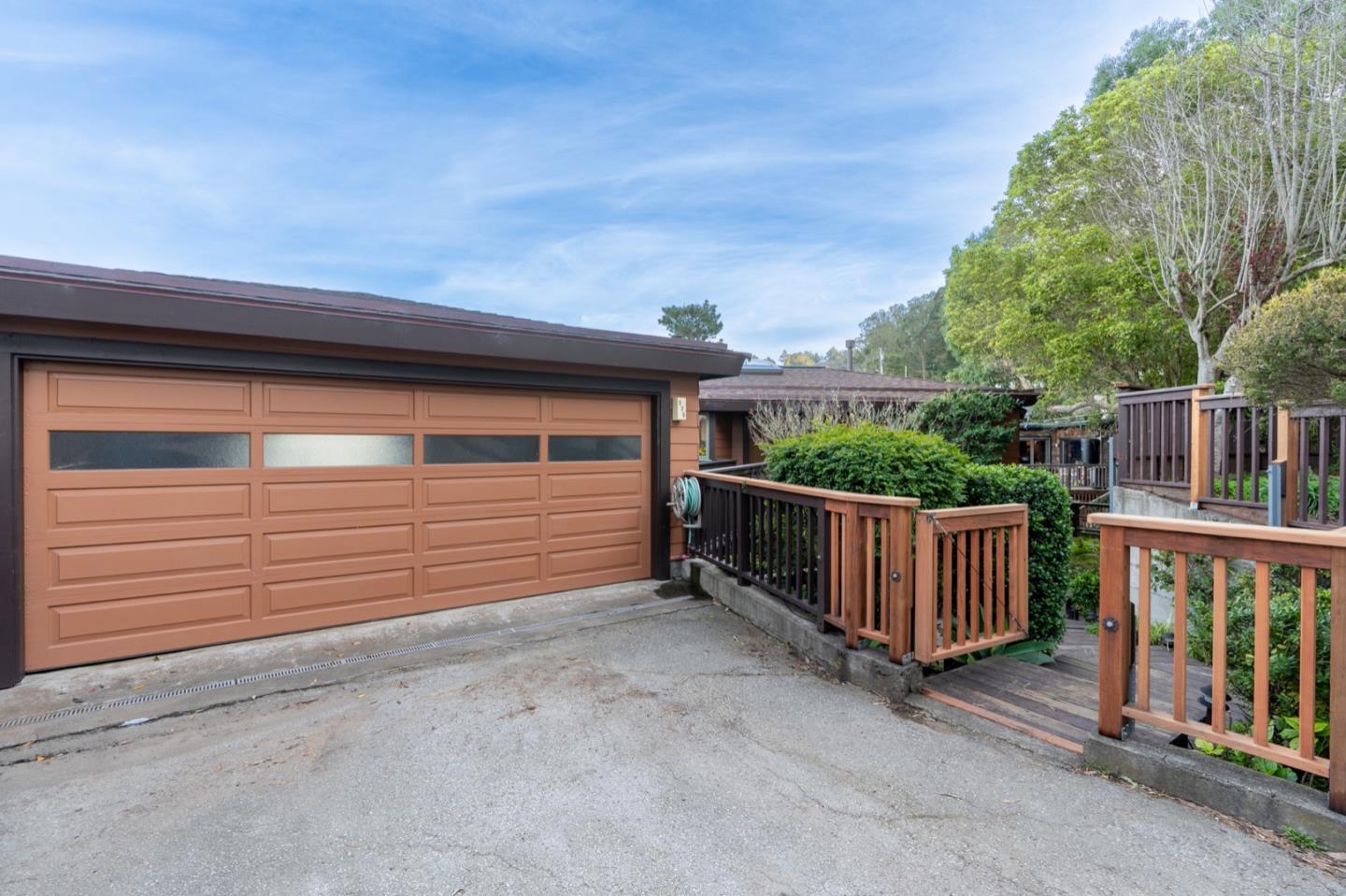 a view of a backyard with parking space and stairs