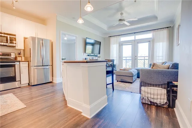 a living room with furniture and a wooden floor