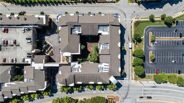 a view of a city with lots of residential buildings ocean and mountain view in back