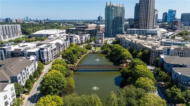 an aerial view of a swimming pool with outdoor seating and yard
