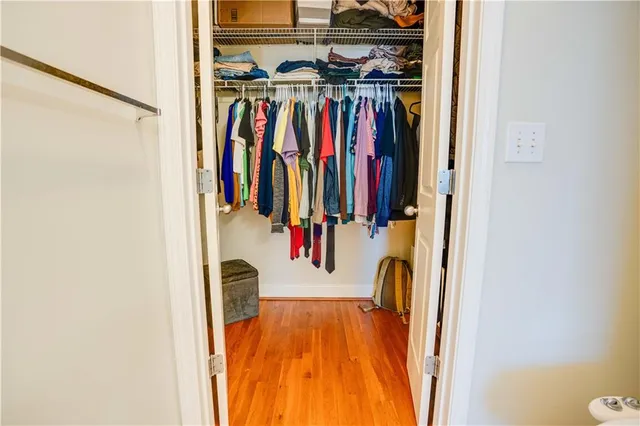 a view of walk in closet with clothes and shoes