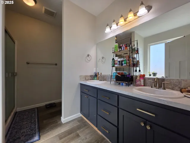 a bathroom with a sink a light fixture and a mirror