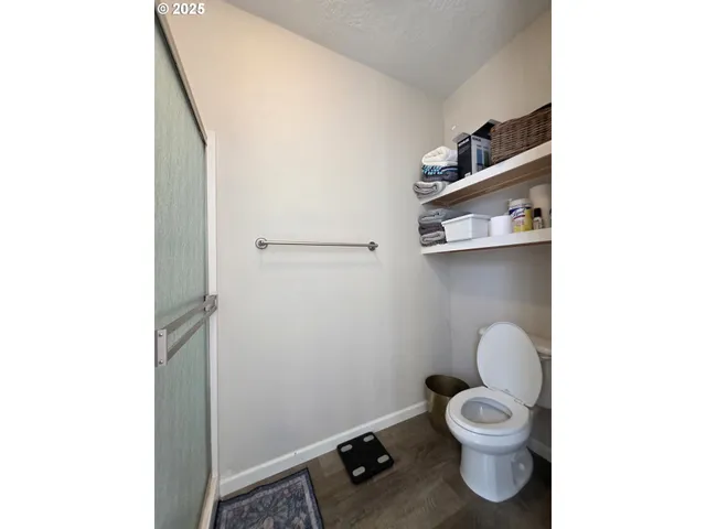 a bathroom with a toilet and a shower