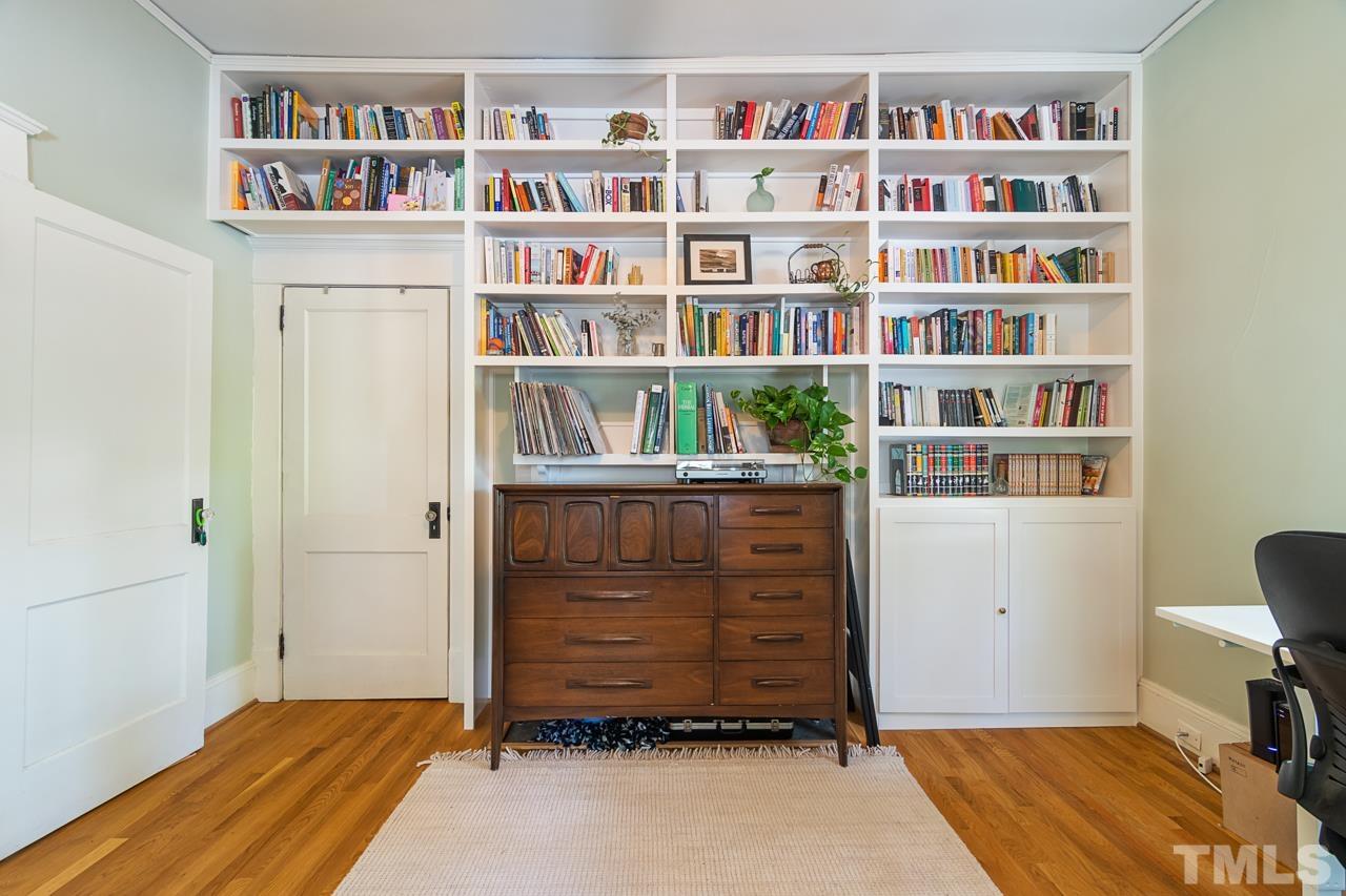 1808 Rosetta Drive Durham, NC 27701 - Photo 16 of 59 a room with a book shelf and a shelf