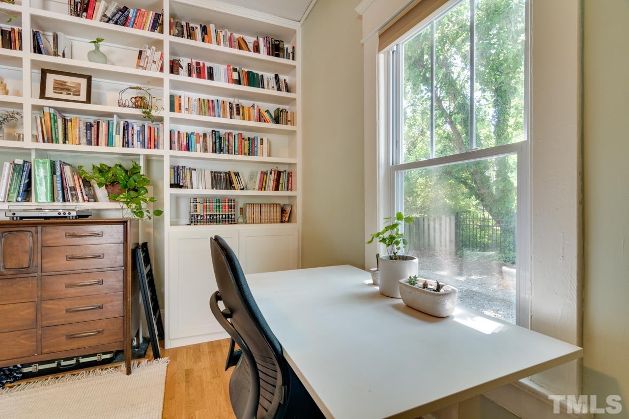 1808 Rosetta Drive Durham, NC 27701 - Photo 17 of 59 a view of a workspace with furniture and a bookshelf