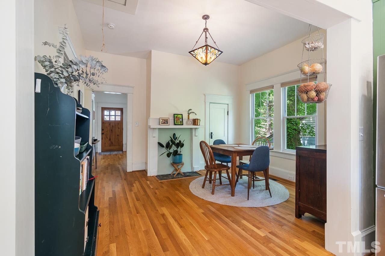 1808 Rosetta Drive Durham, NC 27701 - Photo 23 of 59 a dining room with furniture a chandelier and wooden floor