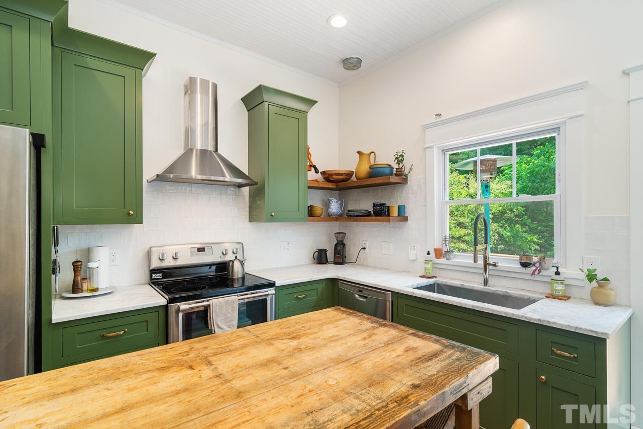 1808 Rosetta Drive Durham, NC 27701 - Photo 29 of 59 a kitchen with stainless steel appliances a sink stove and cabinets