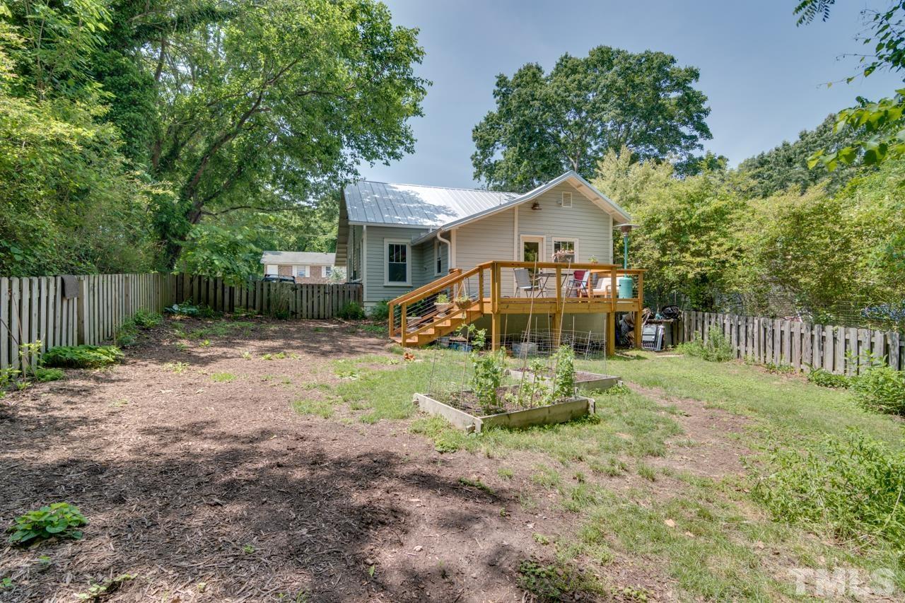 1808 Rosetta Drive Durham, NC 27701 - Photo 48 of 59 a view of a house with a yard and wooden fence