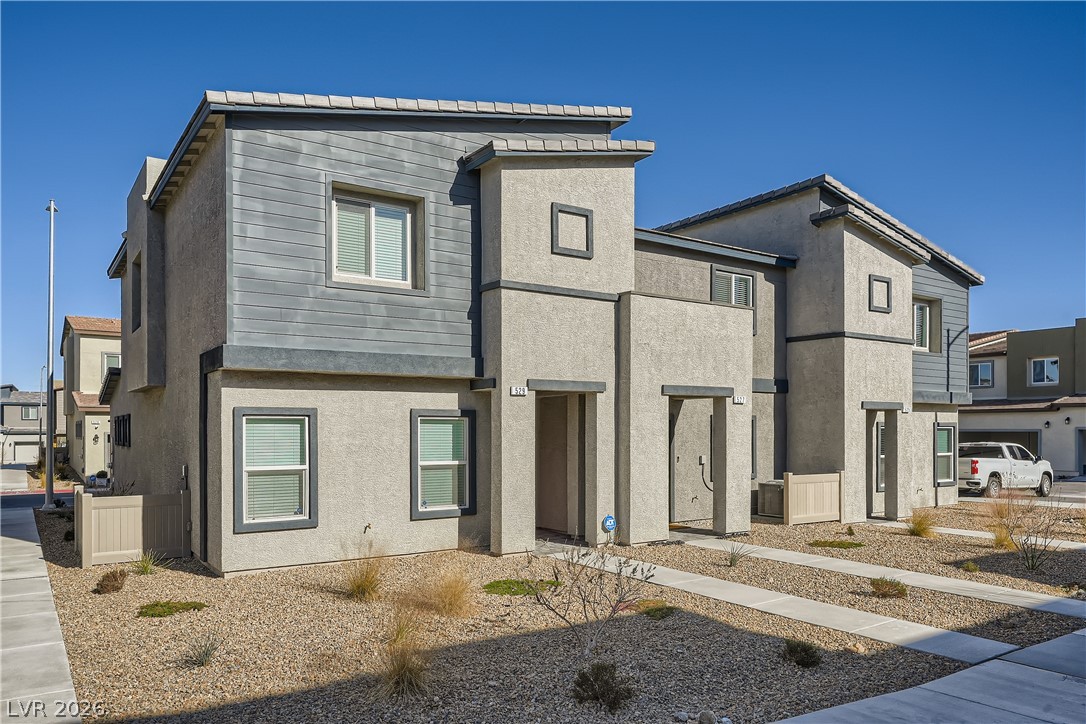 Contemporary home featuring stucco siding