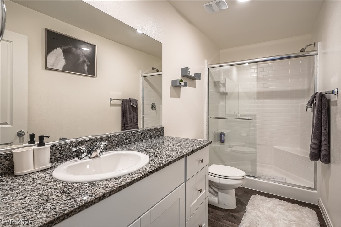 527 Clearsable Avenue Henderson, NV 89044 - Photo 5 of 11 Bathroom featuring vanity, a stall shower, and dark wood-style flooring
