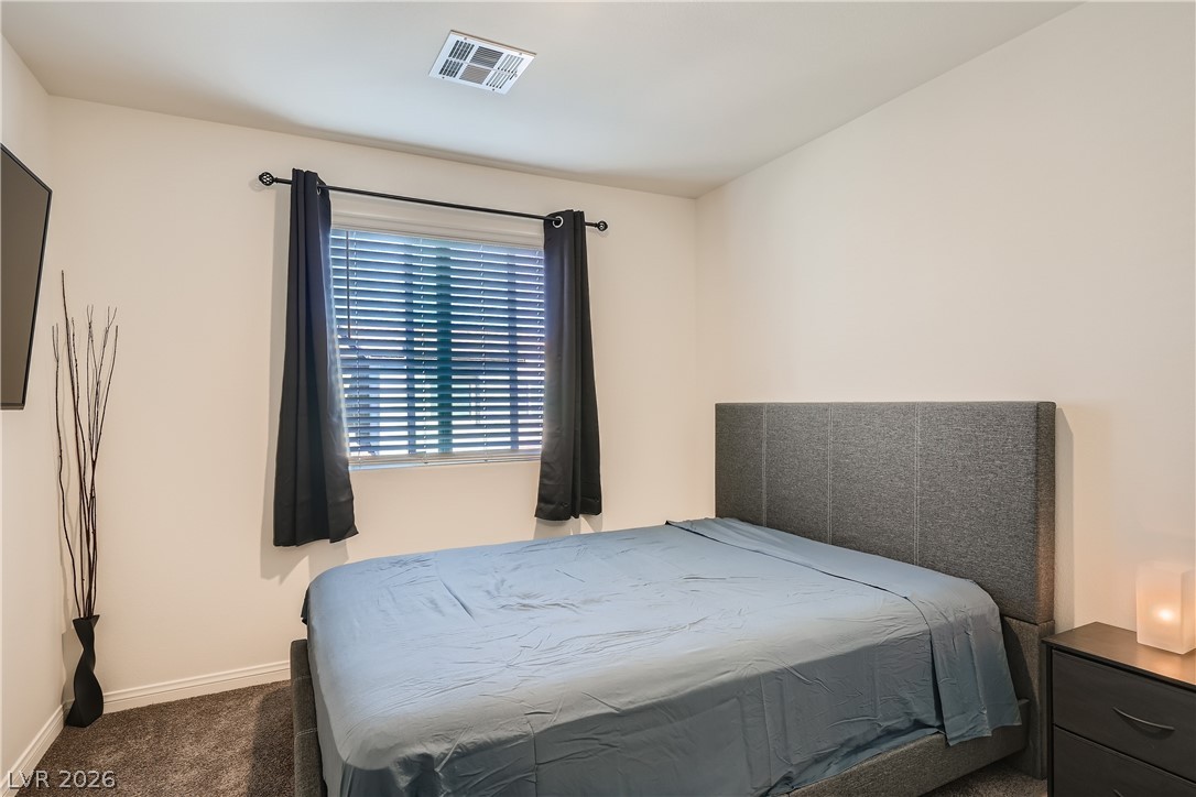 527 Clearsable Avenue Henderson, NV 89044 - Photo 7 of 11 Bedroom featuring dark carpet and baseboards