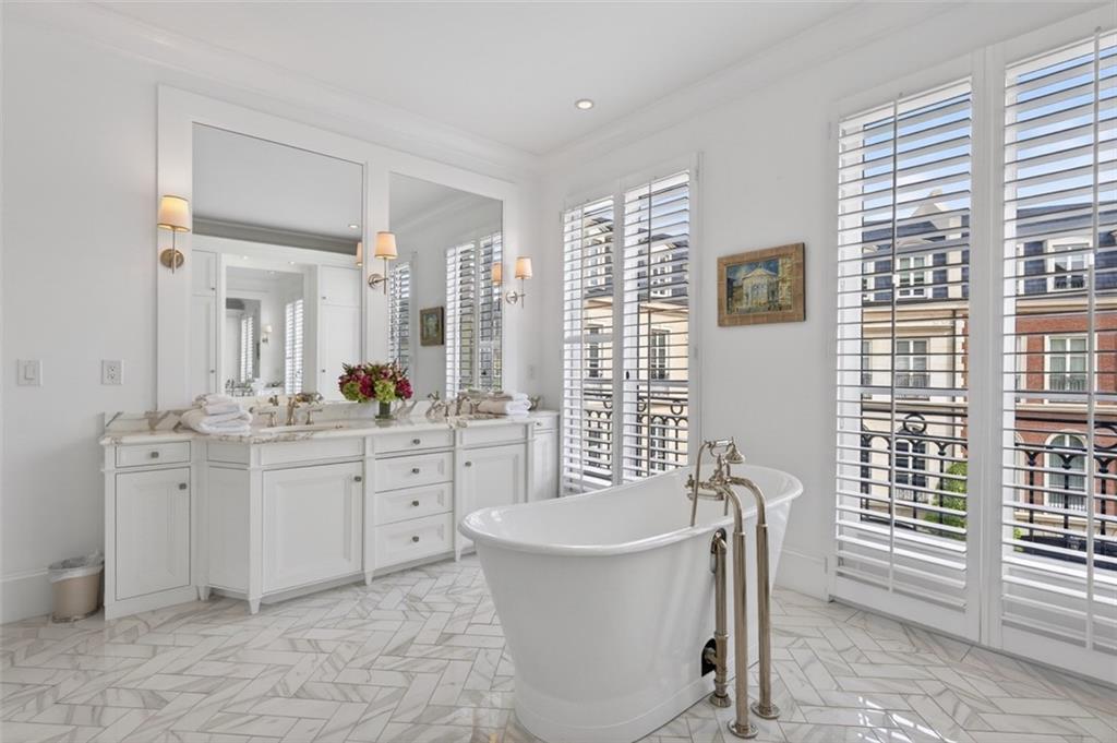 2288 Peachtree Road Northwest, Unit 4 Atlanta, GA 30309 - Photo 21 of 50 a spacious bathroom with a double vanity sink a mirror a bathtub and next to a window