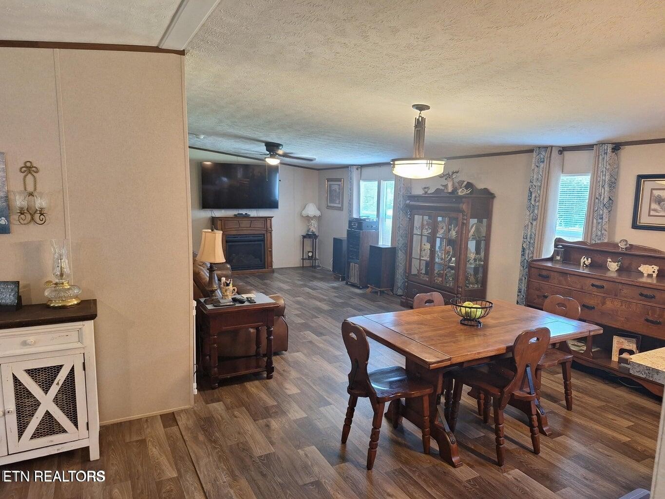 1450 Belltown Road Tellico Plains, TN 37385 - Photo 12 of 32 a view of a dining room with furniture and wooden floor