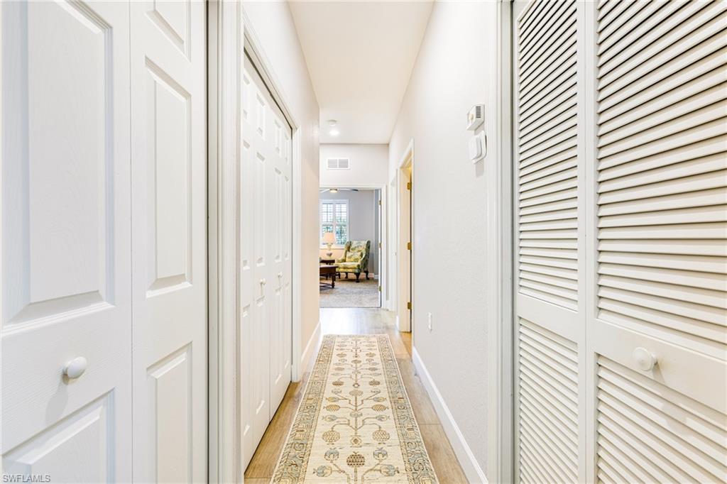 19081 Ridgepoint Drive, Unit 202 Estero, FL 33928 - Photo 16 of 50 a view of a hallway with wooden floor and staircase