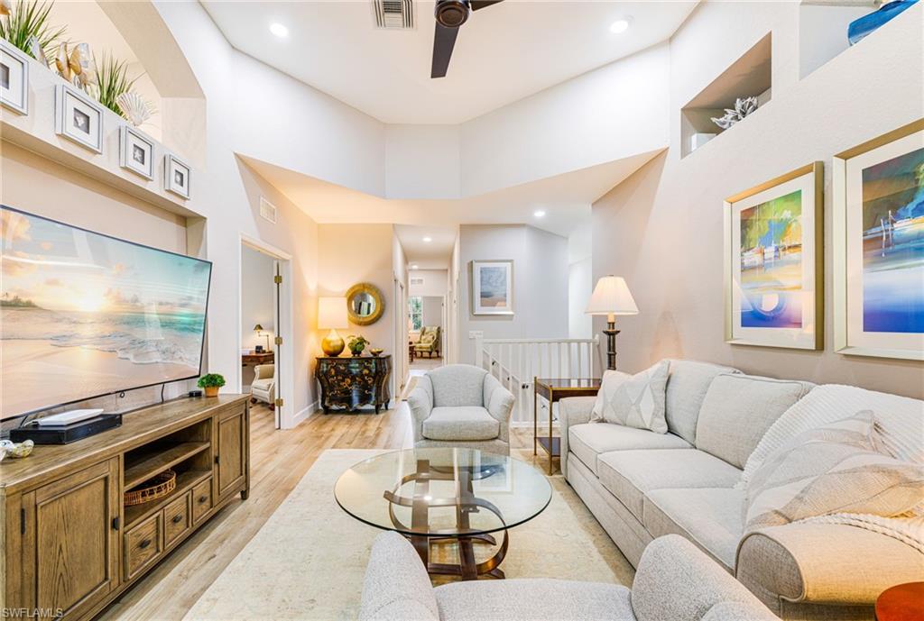 19081 Ridgepoint Drive, Unit 202 Estero, FL 33928 - Photo 2 of 50 a living room with furniture flat screen tv and couches