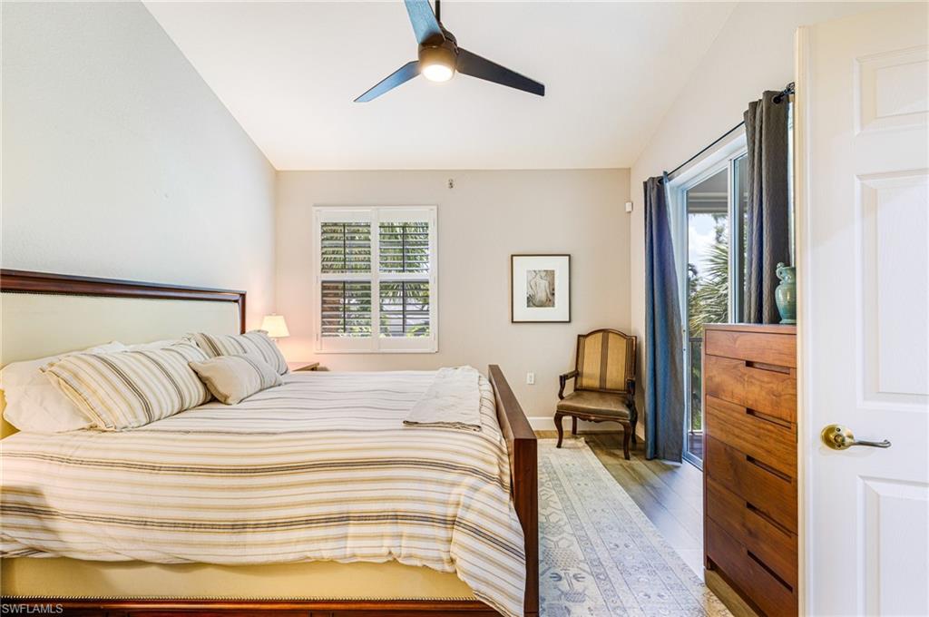 19081 Ridgepoint Drive, Unit 202 Estero, FL 33928 - Photo 21 of 50 a bedroom with a bed large mirror and furniture