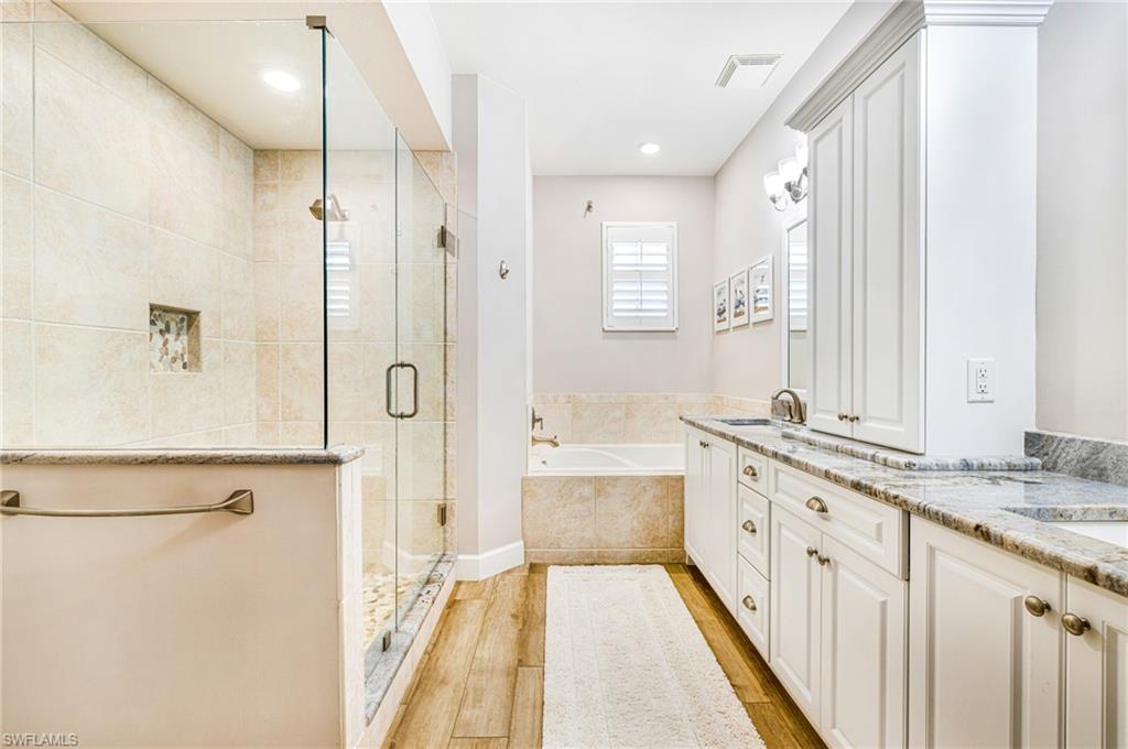 19081 Ridgepoint Drive, Unit 202 Estero, FL 33928 - Photo 23 of 50 a spacious bathroom with a granite countertop sink mirror and a bathtub