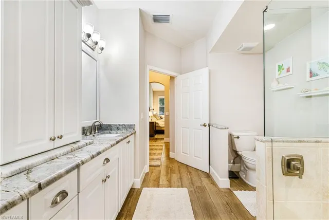 a bathroom with a sink a mirror and a shower